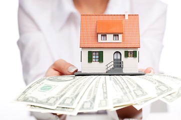 Image showing Hands with money and miniature house on a white background