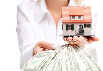 Image showing Hands with money and miniature house on a white background