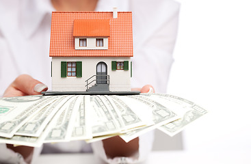 Image showing Hands with money and miniature house on a white background