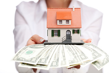 Image showing Hands with money and miniature house on a white background