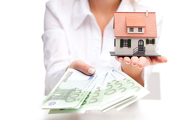 Image showing Little house toy and money in woman's hands