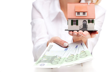 Image showing Little house toy and money in woman's hands