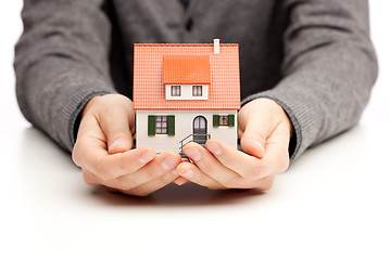 Image showing Hands holding a small house