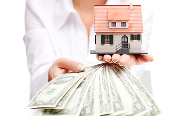 Image showing Hands with money and miniature house on a white background