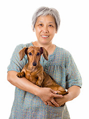 Image showing Mature asian woman with dachshund dog