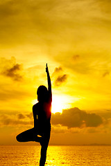 Image showing Woman doing yoga at sunset time