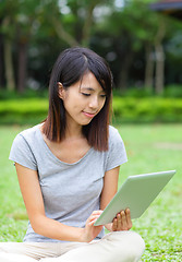 Image showing Asian woman looking at computer tablet