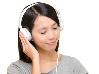 Image showing Asian woman listen to music