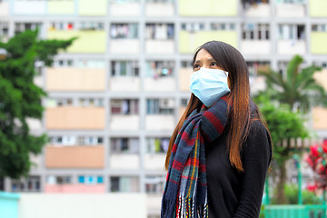 Image showing Woman wearing medical face mask in crowded city