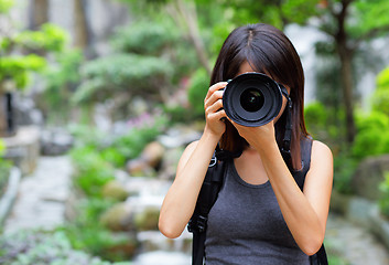 Image showing Asian woman taking photo with backpack