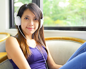 Image showing Asian woman listen to music