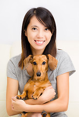 Image showing Asian woman and dachshund dog