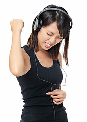 Image showing Asian woman listen to rock music