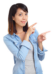 Image showing Asian woman pointing a side