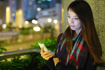 Image showing Woman using smartphone in city at night