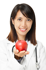 Image showing Asian female doctor holding red apple