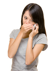 Image showing Asian woman talking phone secretly 