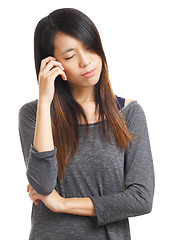 Image showing young woman with headache holding head