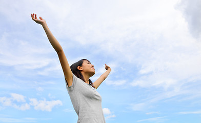 Image showing Asian woman hand up with blue sky background