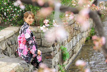 Image showing Young woman wearing Japanese kimono with cherry blossom