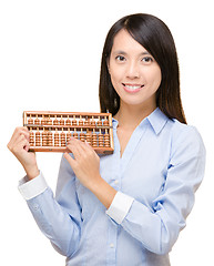 Image showing Asian woman holding abacus