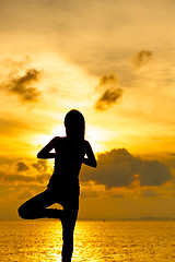 Image showing Woman doing yoga at sunset time