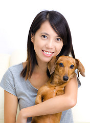 Image showing Asian woman with dachshund dog