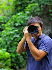 Image showing Asian man taking photo