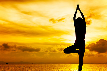 Image showing Woman doing yoga at sunset time