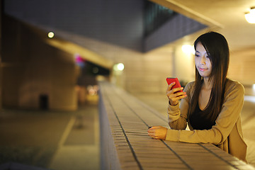 Image showing woman using mobile phone in city at night
