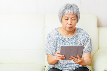 Image showing Asian old woman using digital tablet