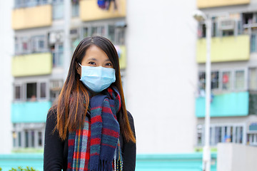 Image showing Woman wearing medical face mask in crowded city