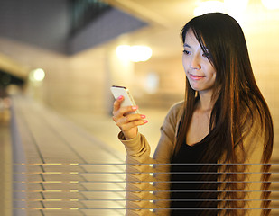 Image showing Asian woman using smartphone at night 