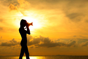 Image showing Silhouette photographer at sunset