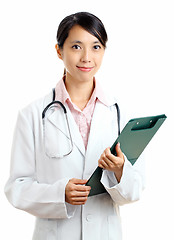 Image showing Asian female doctor with writing pad