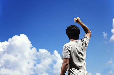 Image showing Man clench fist facing the sky