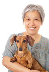 Image showing Asian old woman and dachshund dog