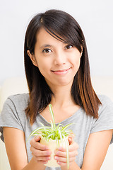 Image showing Asian woman with potted plant