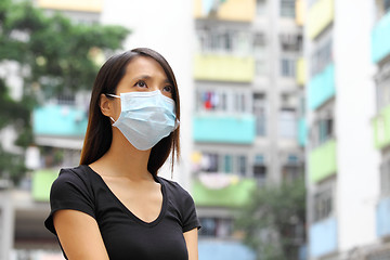 Image showing Woman wearing medical face mask in crowded city