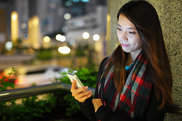 Image showing Woman using smartphone in city at night