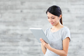 Image showing young asian woman using tablet computer