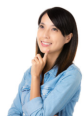 Image showing Asian thoughtful woman looking up
