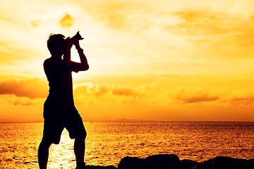 Image showing Silhouette of photographer at sunset