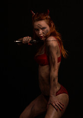 Image showing dark red devil girl with a knife