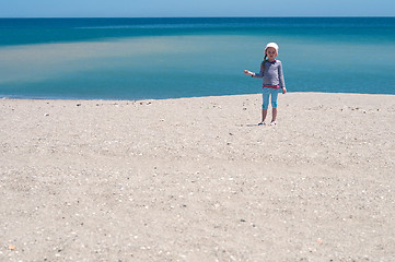 Image showing Little girl playing on the beach