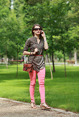 Image showing Young Woman on the Phone Walking in a Park 