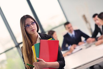 Image showing business woman with her staff in background at office