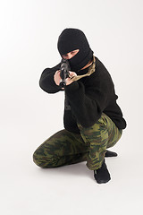 Image showing masked man aims with rifle