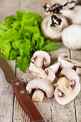 Image showing champignons with parsley and old knife 
