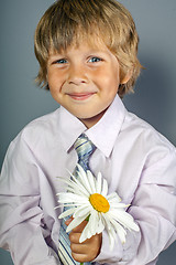 Image showing handsome boy with flowers in hands